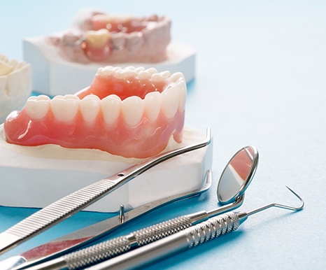 Closeup of dentures in Spring and dental tools 