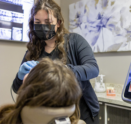 Dental team member examining a patient's teeth