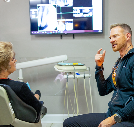 Doctor Kuykendall explaining a treatment to a patient