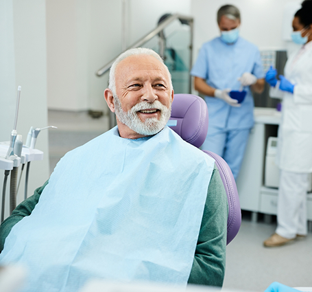 Smiling senior man in the dental chair
