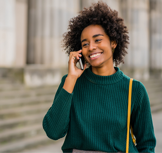 Person smiling while talking on the phone