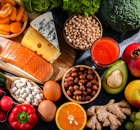 Plate covered in fruits, vegetables, meats, nuts, and other healthy foods