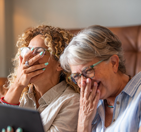Two older women laughing together