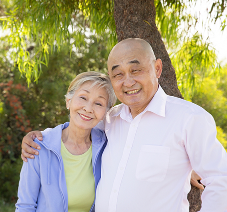 Smiling senior couple standing in the sun