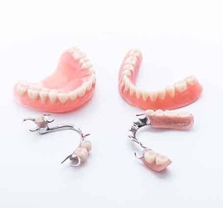 a dentist holding a set of dentures