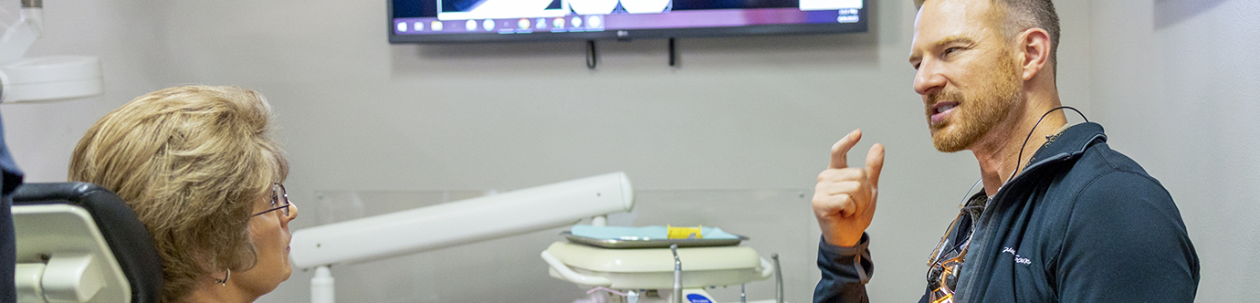 Dentist talking with a patient