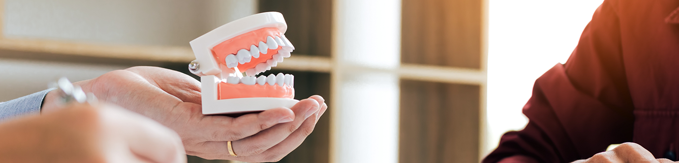 Dental patient at a consultation to replace missing teeth in Spring