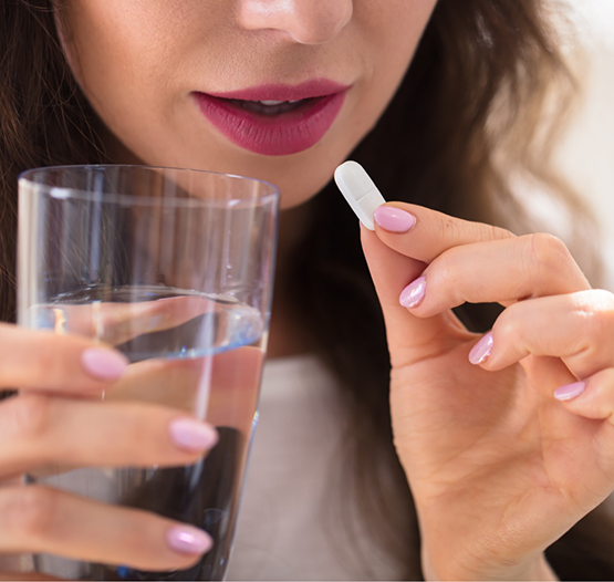 Woman taking a pill