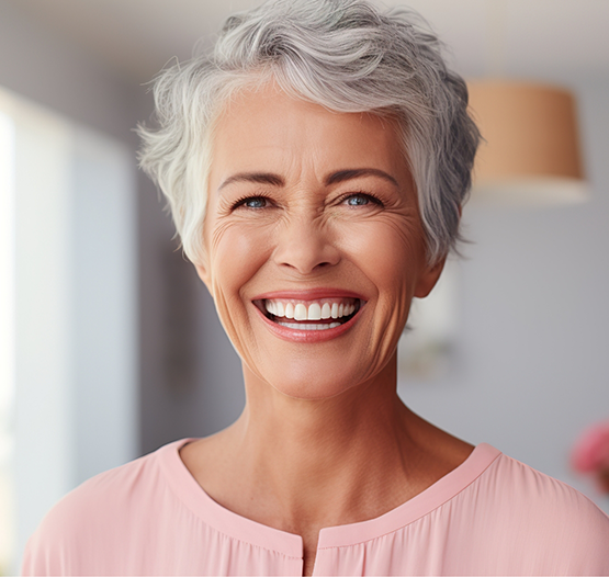 Smiling senior woman in a pink blouse