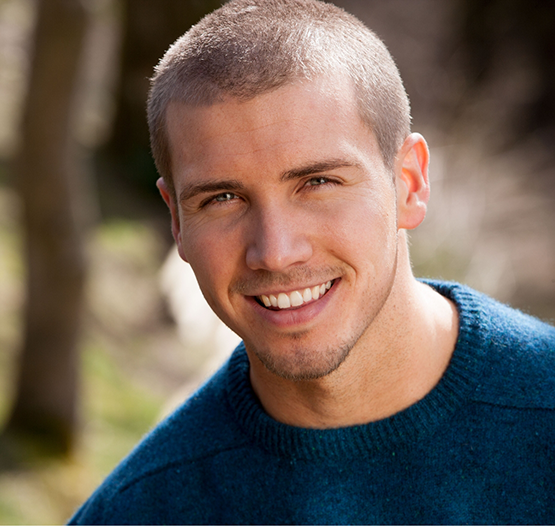 Smiling man in a blue sweater