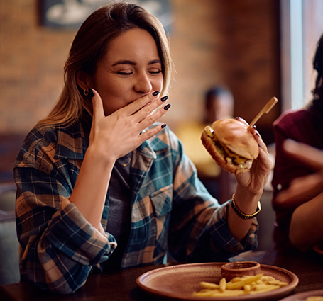 Woman eating a burger at a restaurant