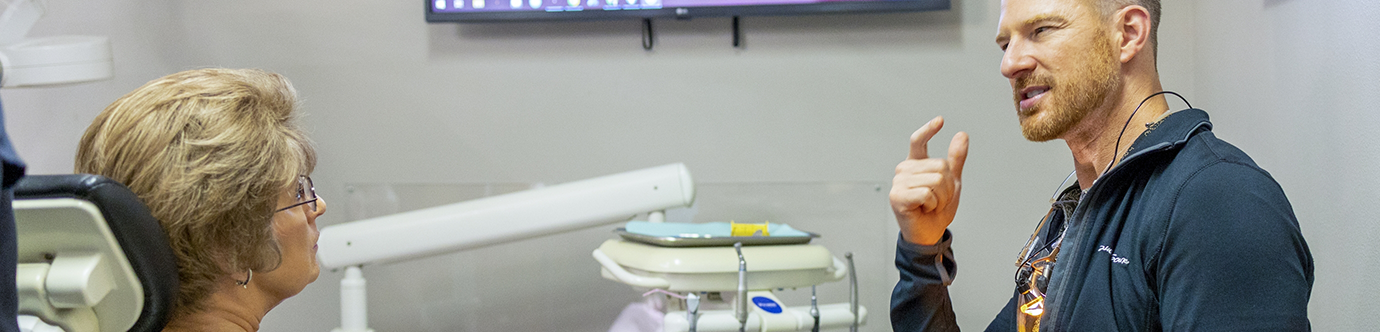 Spring dentist Doctor Joshua Kuykendall talking with a patient
