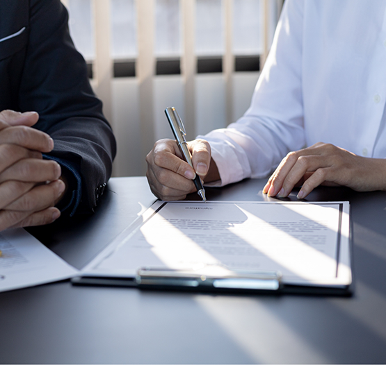 Two people filling out paperwork