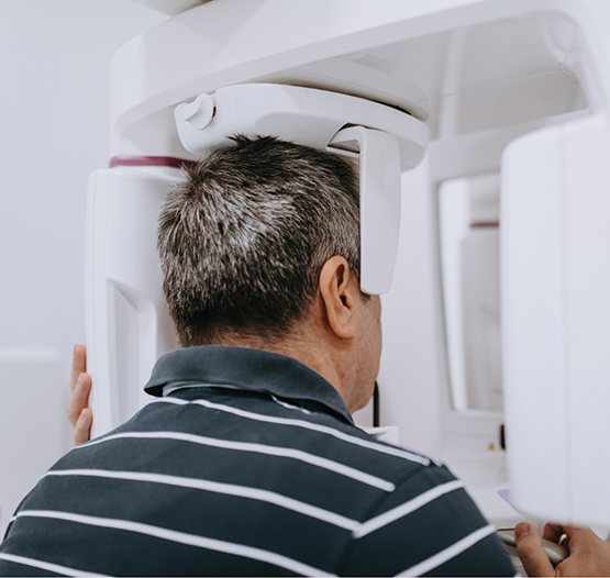 Dental patient getting a cone beam CT scan of his mouth and jaws