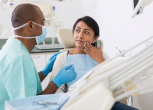 Patient explaining her toothache symptoms to dentist